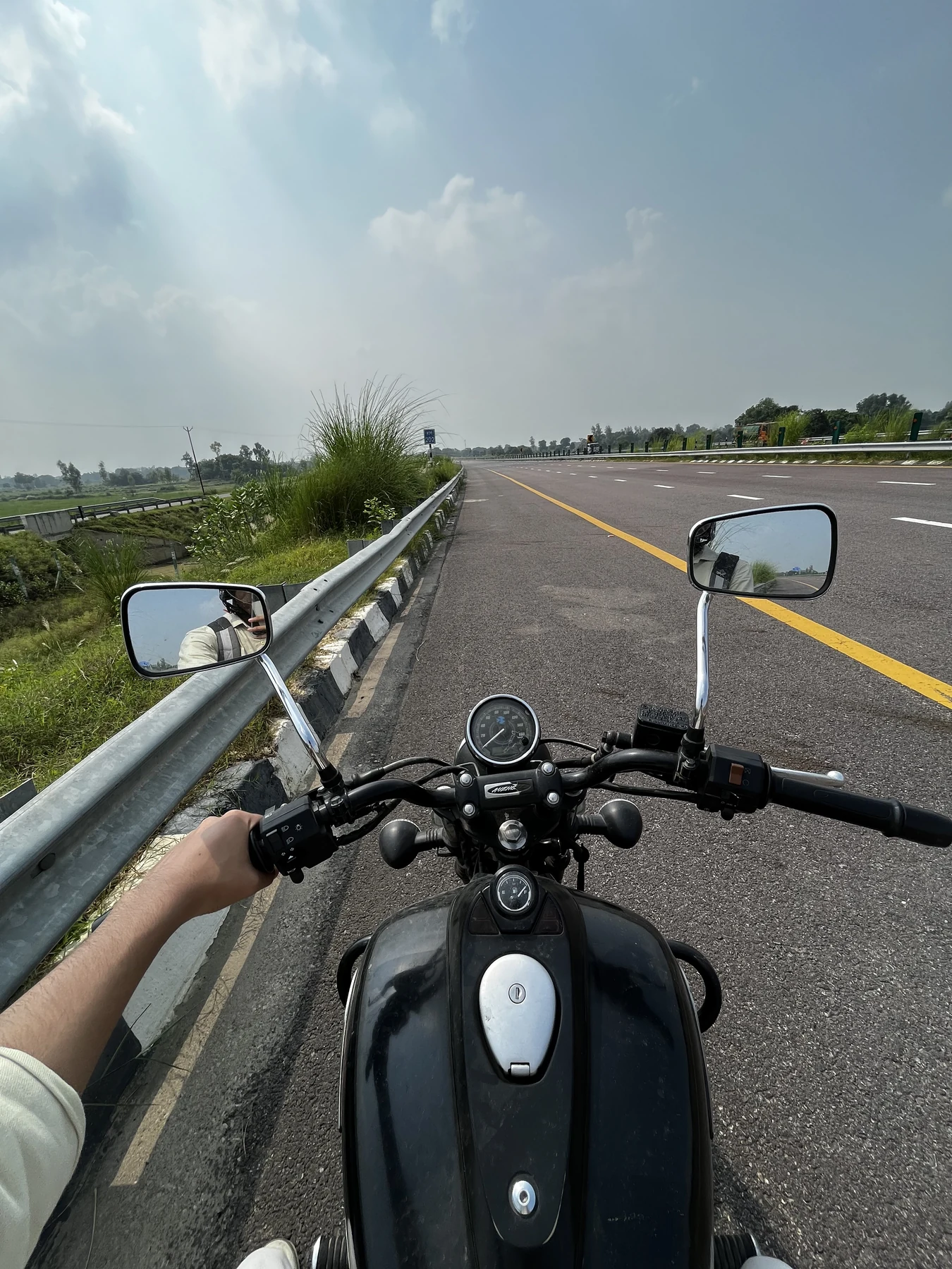 Riding a motorcycle down an empty highway