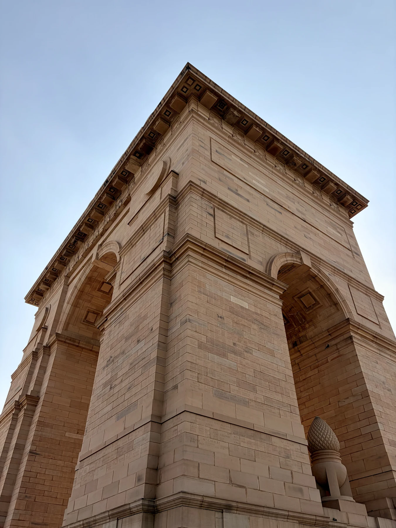 Sandstone arch monument against a clear sky